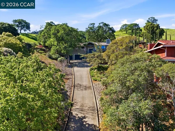 a front view of a house with yard garage and outdoor seating