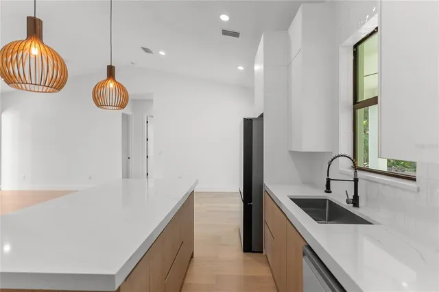 a view of a kitchen with a sink and a window