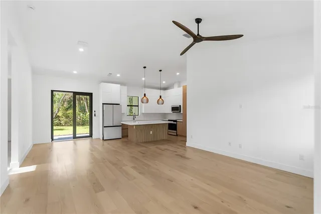 an empty room with windows and closet