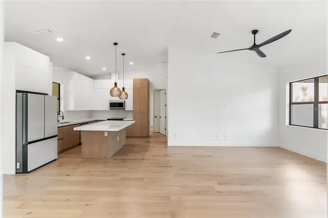 a view of backyard with large trees and plants