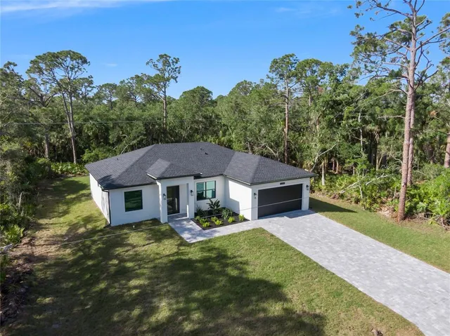 an aerial view of a house with yard