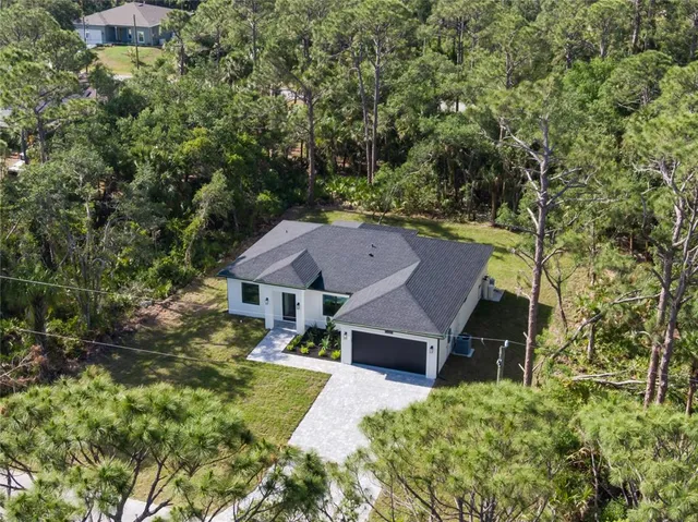 an aerial view of a house with a yard