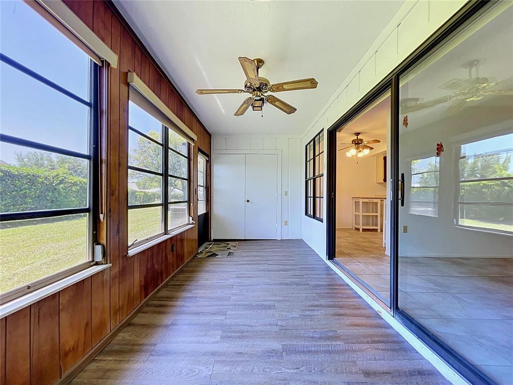 9319 Trowbridge Court New Port Richey, FL 34655 - Photo 36 of 78 a view of a hallway with wooden floor and windows