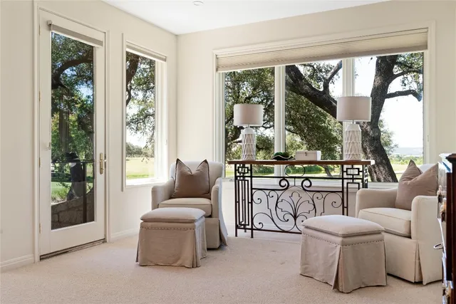 a living room with furniture and a floor to ceiling window