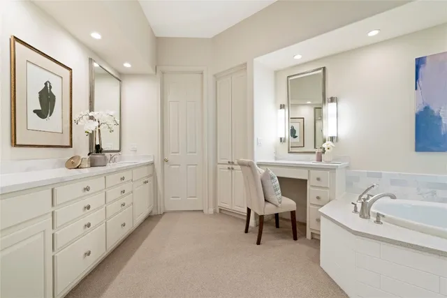 a bathroom with a granite countertop sink mirror and bathtub