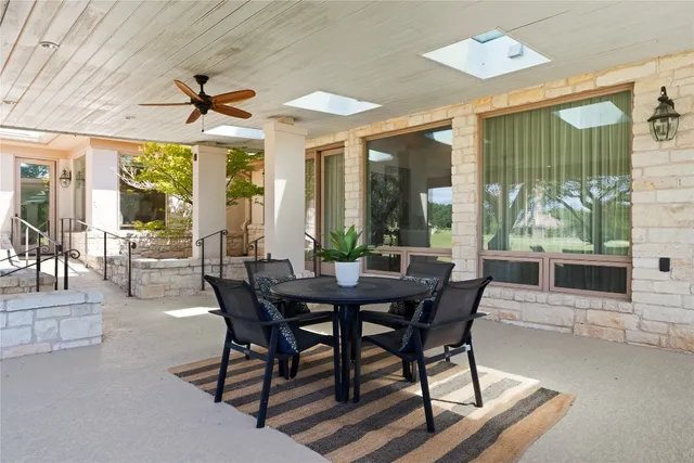 a dining room with furniture a chandelier and fireplace