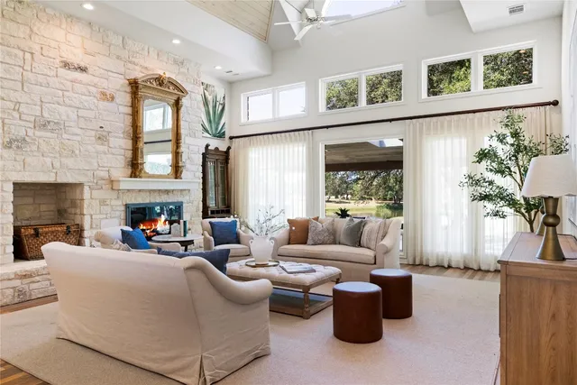 a living room with furniture large window and fireplace