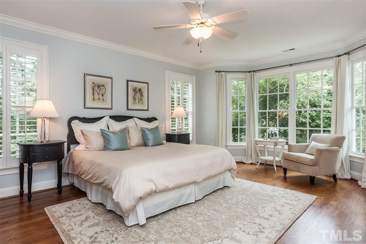 607 Runnymede Road Raleigh, NC 27607 - Photo 12 of 25 a bedroom with a large bed and a couch
