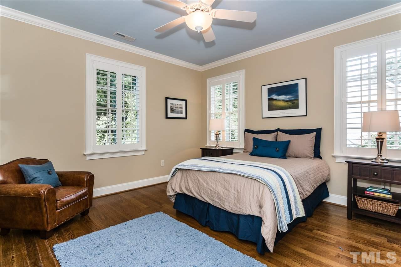 607 Runnymede Road Raleigh, NC 27607 - Photo 15 of 25 a bedroom with a bed couch and window
