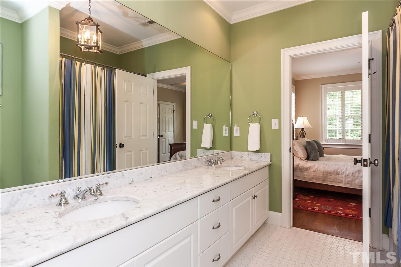607 Runnymede Road Raleigh, NC 27607 - Photo 16 of 25 a en suite bathroom with a double vanity sink and a mirror
