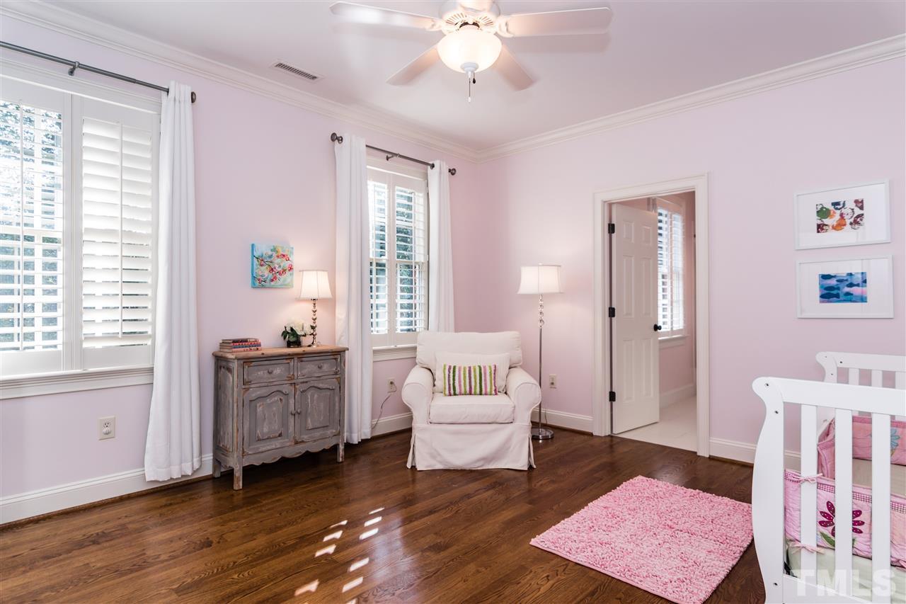 607 Runnymede Road Raleigh, NC 27607 - Photo 18 of 25 a spacious bedroom with a bed and a couch