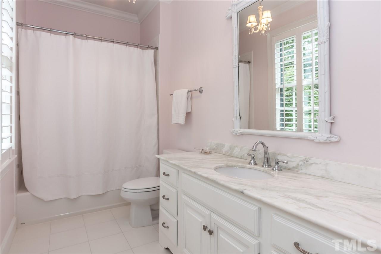 607 Runnymede Road Raleigh, NC 27607 - Photo 19 of 25 a bathroom with a granite countertop sink a toilet and a mirror