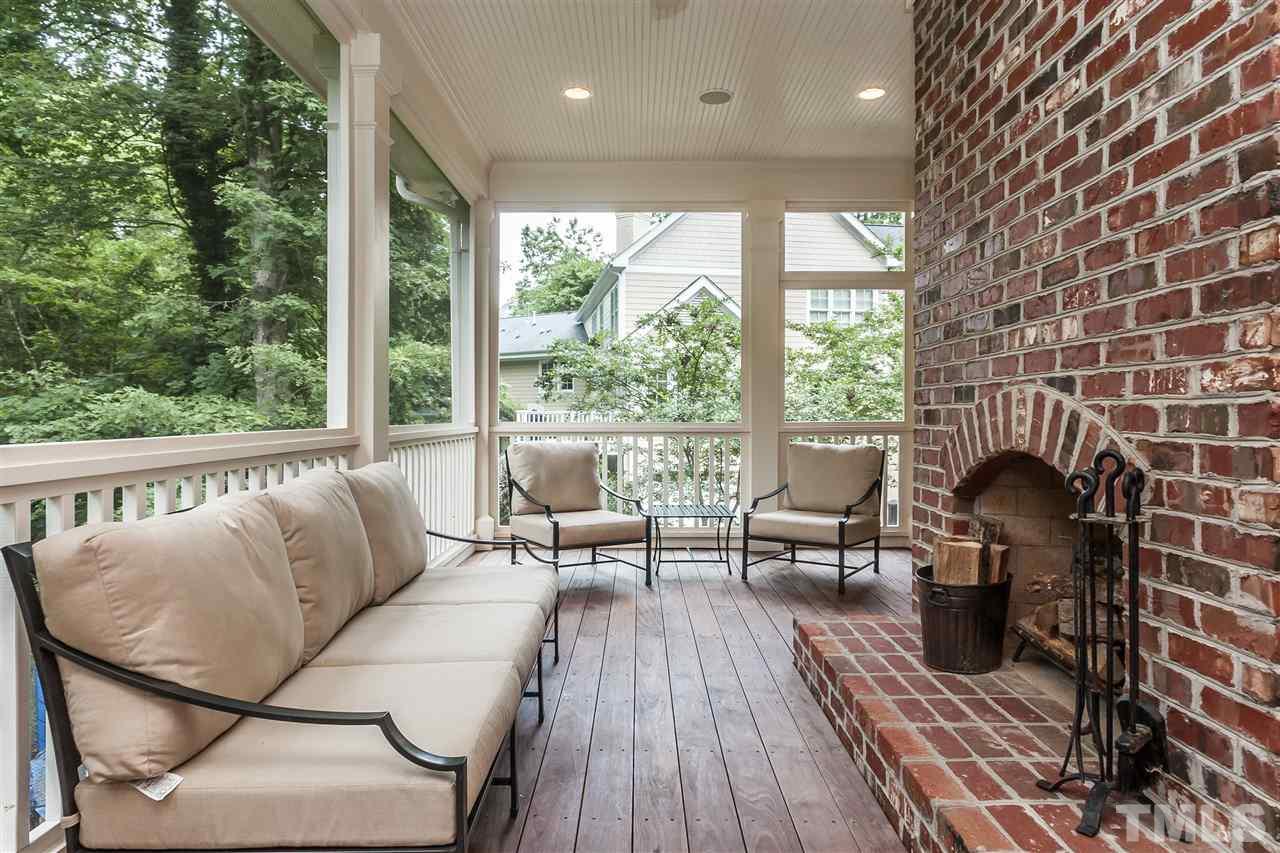 607 Runnymede Road Raleigh, NC 27607 - Photo 23 of 25 a living room with furniture a large window and wooden floor