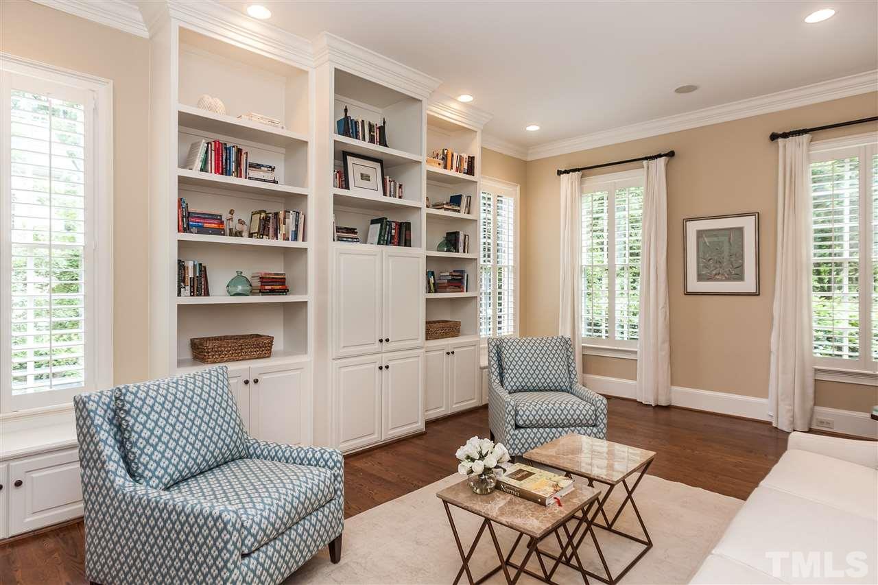 607 Runnymede Road Raleigh, NC 27607 - Photo 4 of 25 a living room with furniture and a book shelf