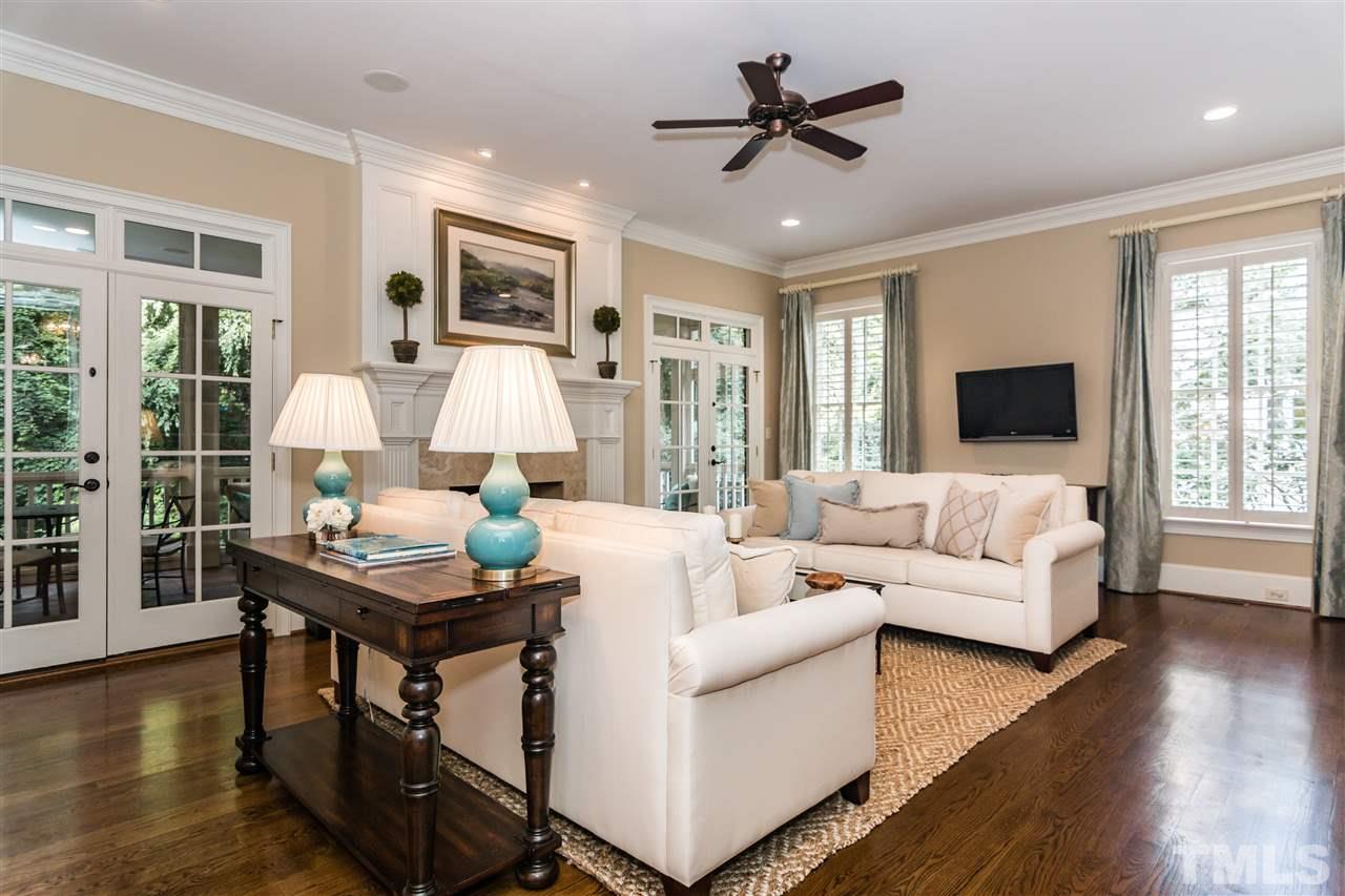 607 Runnymede Road Raleigh, NC 27607 - Photo 5 of 25 a living room with furniture fireplace and a large window