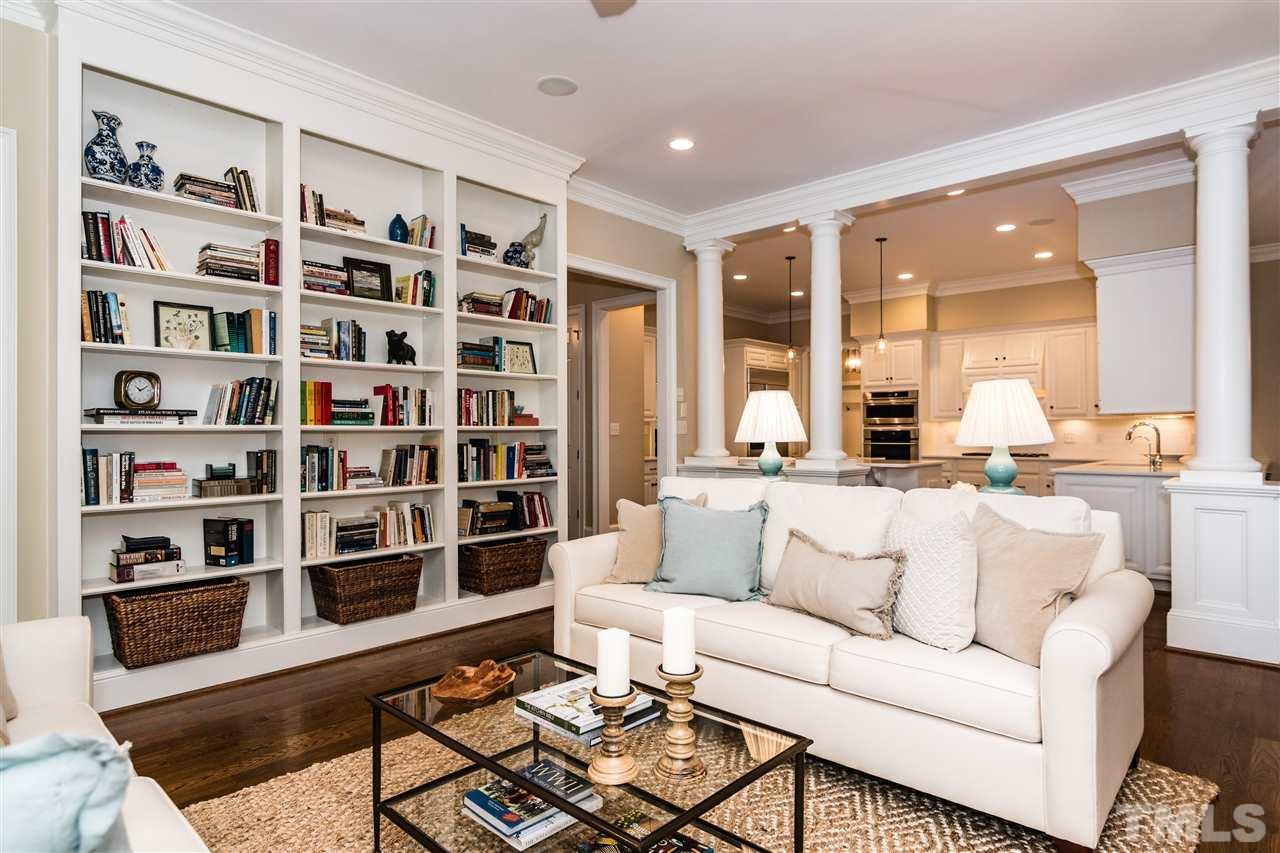 607 Runnymede Road Raleigh, NC 27607 - Photo 6 of 25 a living room with furniture and a book shelf