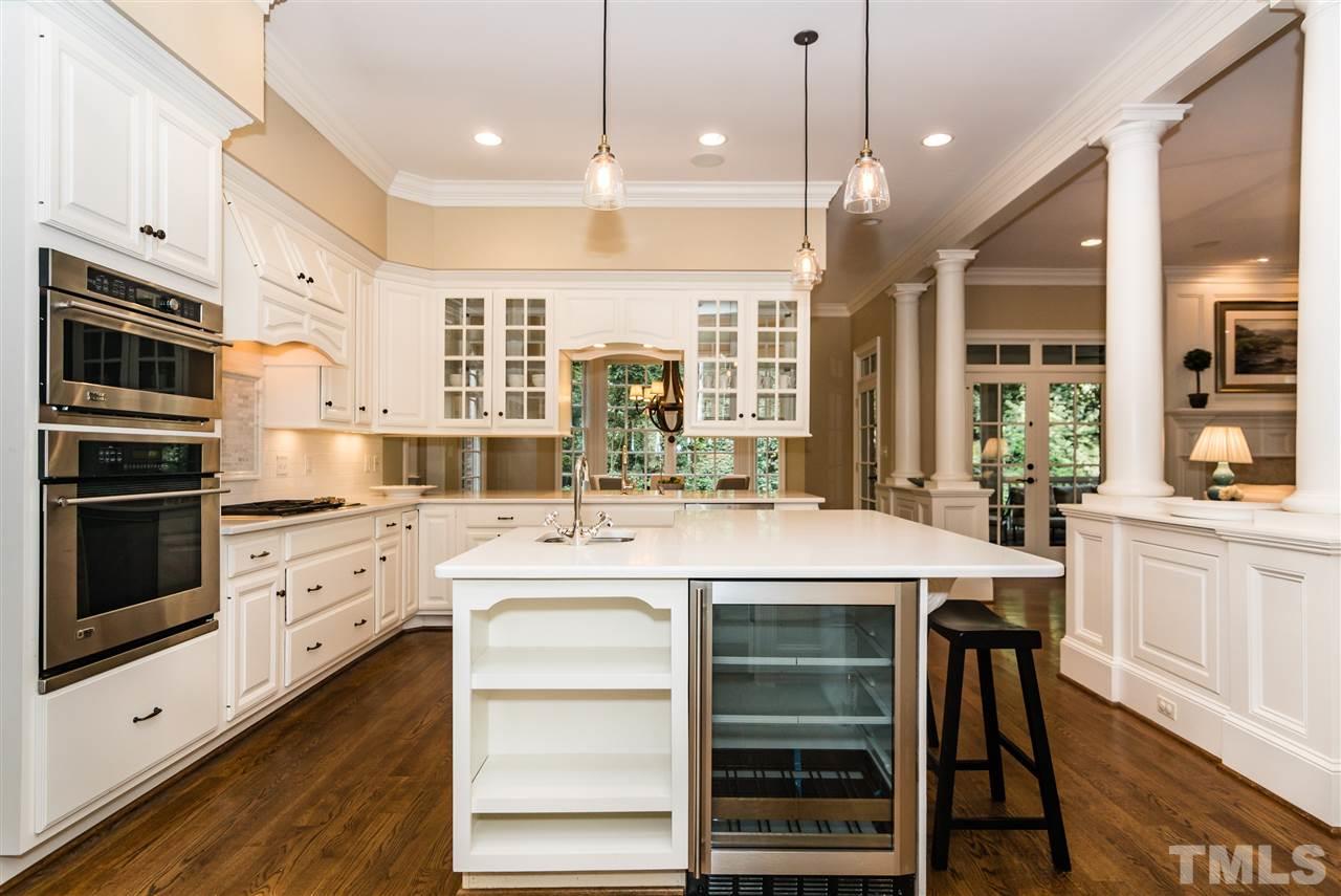 607 Runnymede Road Raleigh, NC 27607 - Photo 7 of 25 a kitchen with stainless steel appliances granite countertop a stove and white cabinets
