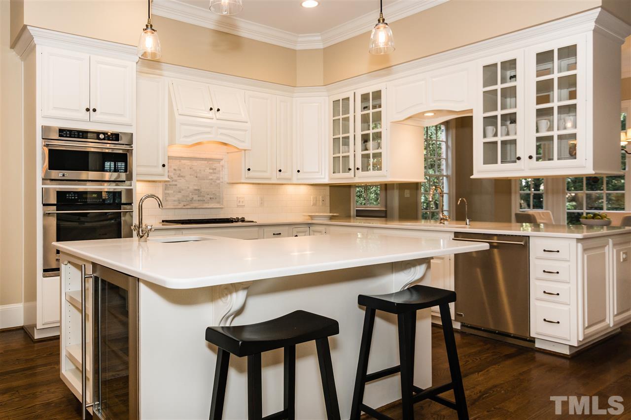 607 Runnymede Road Raleigh, NC 27607 - Photo 8 of 25 a kitchen with a table chairs stove and cabinets