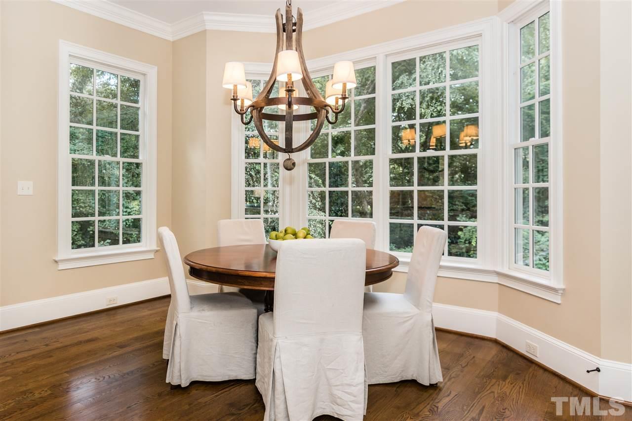 607 Runnymede Road Raleigh, NC 27607 - Photo 10 of 25 a dining room with furniture large windows and wooden floor