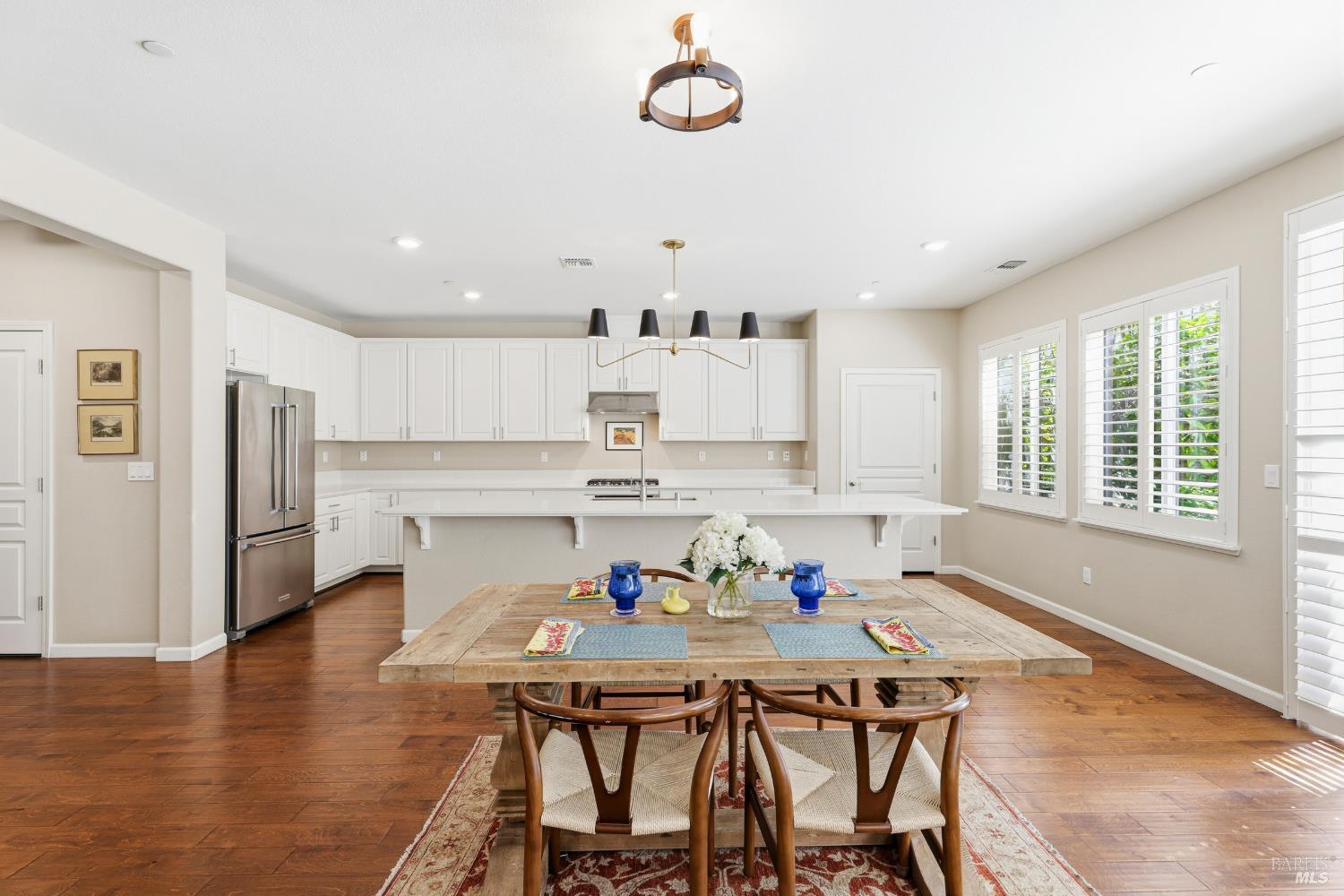 5533 Kennedy Place Rohnert Park, CA 94928 - Photo 11 of 63 a kitchen with stainless steel appliances granite countertop a dining table chairs refrigerator and sink