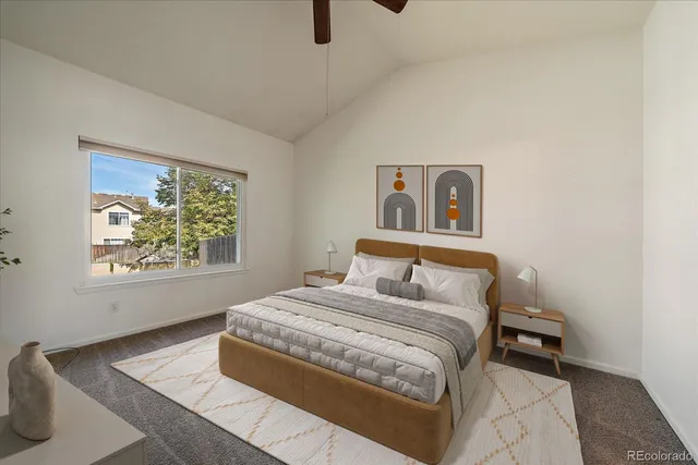 a bedroom with a bed and a painting on the wall