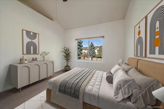 a bedroom with two beds and painting on the wall