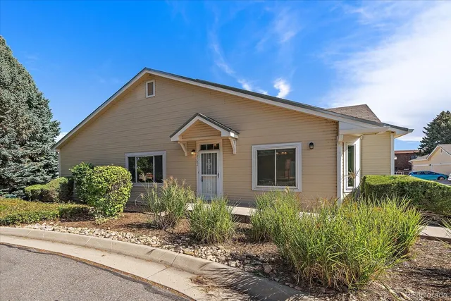 a view of a house with a yard and plants