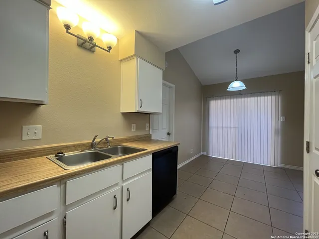 a kitchen with a sink and cabinets