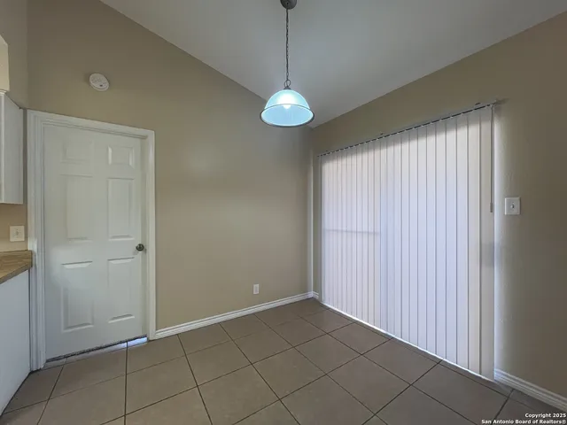 a view of a room with a mirror and a window