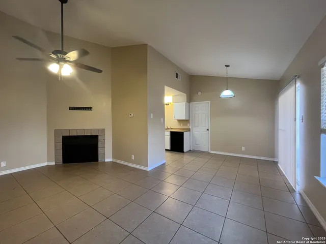 a view of an empty room with a fireplace