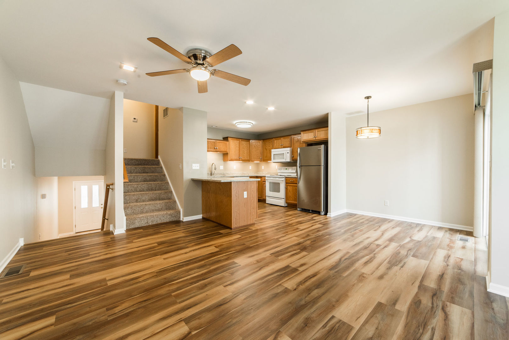 630 South Peace Road Sycamore, IL 60178 - Photo 5 of 21 a view of an empty room with wooden floor and a ceiling fan