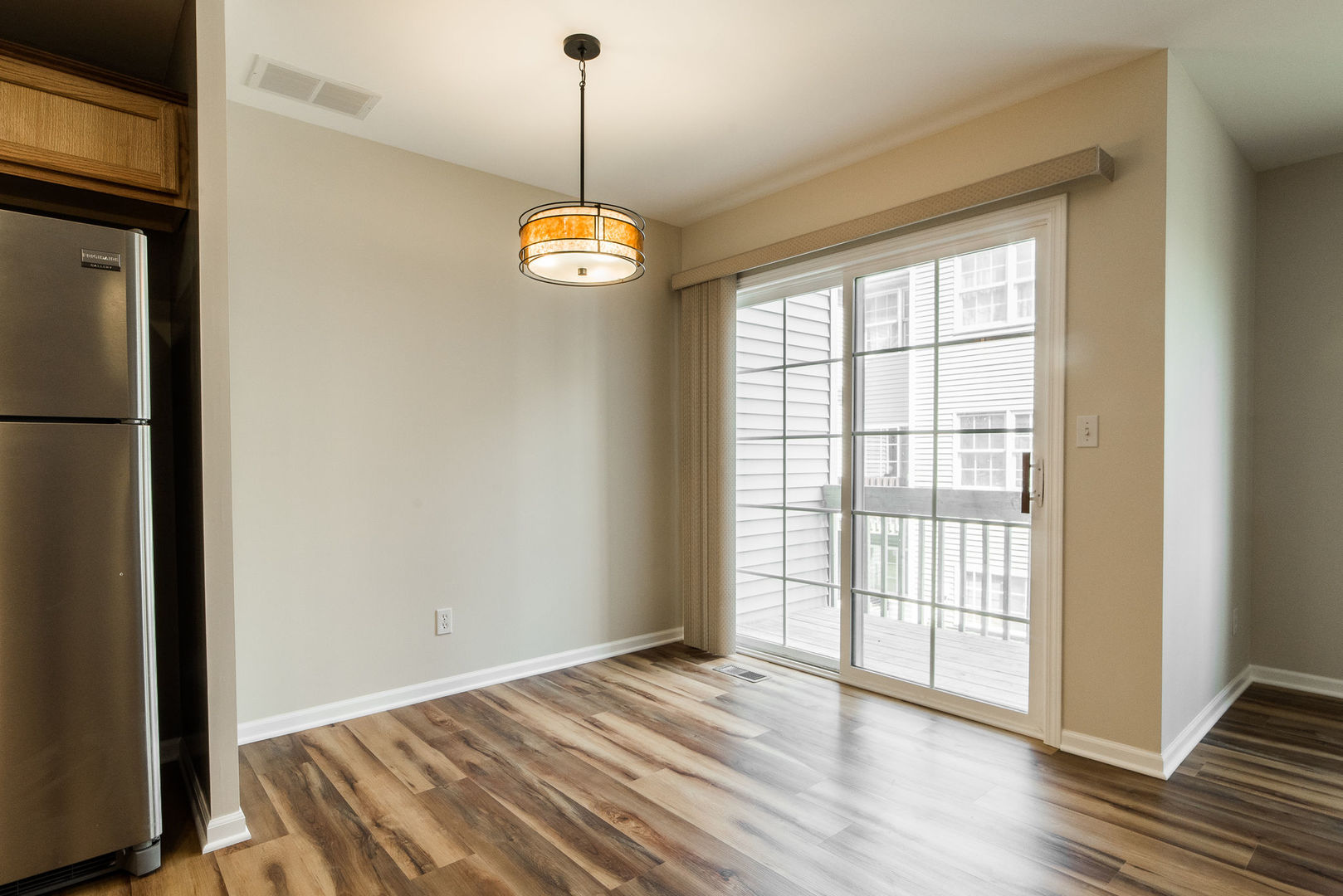 630 South Peace Road Sycamore, IL 60178 - Photo 6 of 21 a view of an empty room with wooden floor and a window