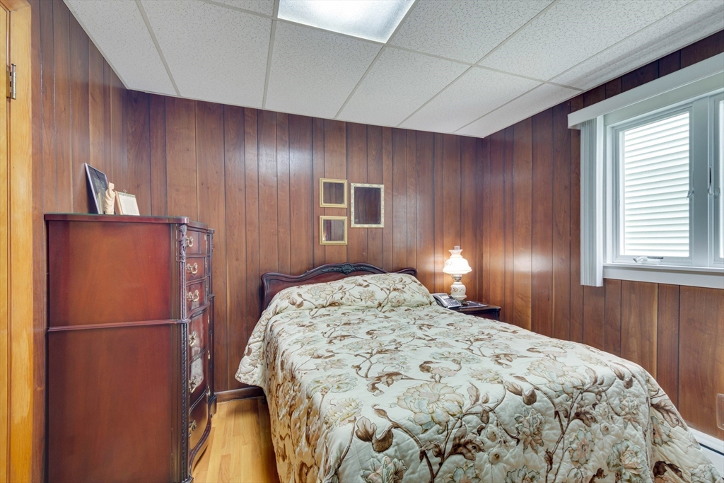 45 Jackson Road Somerville, MA 02145 - Photo 9 of 27 a bedroom with a bed and a refrigerator