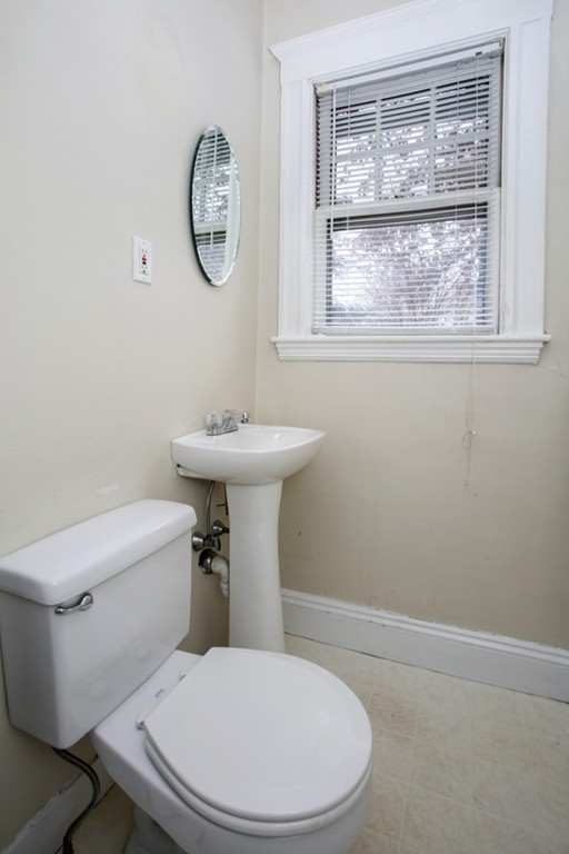 70 Abbottsford Road, Unit 2 Brookline, MA 02446 - Photo 11 of 13 a white toilet sitting next to a bathroom sink