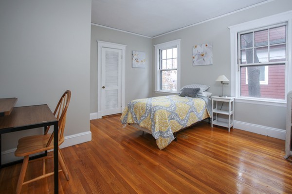 70 Abbottsford Road, Unit 2 Brookline, MA 02446 - Photo 8 of 13 a bedroom with a bed a table and chair