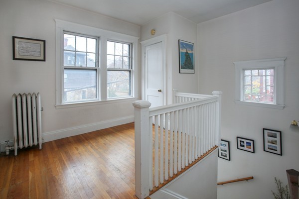 70 Abbottsford Road, Unit 2 Brookline, MA 02446 - Photo 9 of 13 a view of an empty room with wooden floor and a window