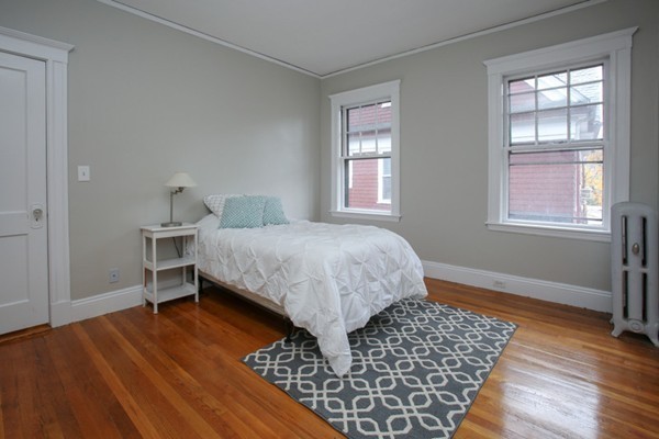 70 Abbottsford Road, Unit 2 Brookline, MA 02446 - Photo 10 of 13 a bedroom with a bed and a window