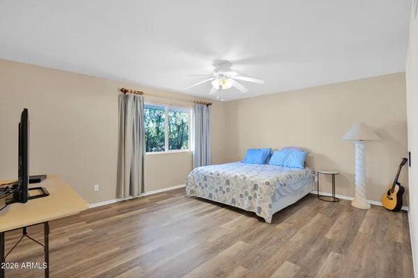 a bedroom with a bed and a flat screen tv