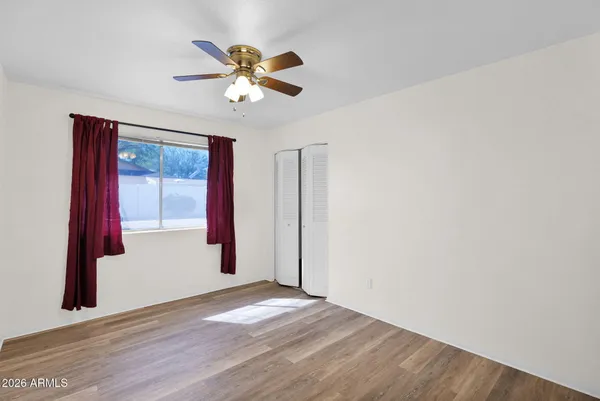 a view of a livingroom with furniture and a hallway