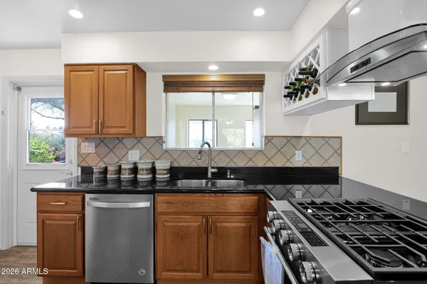 a kitchen with a sink a stove and a microwave
