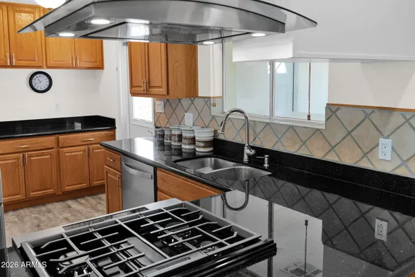 a stove top oven sitting inside of a kitchen