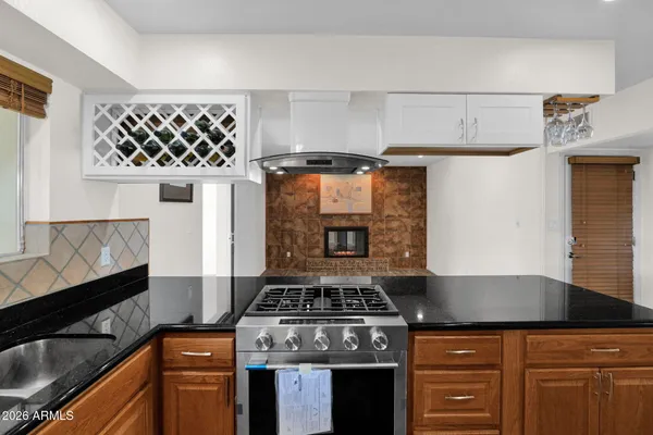a kitchen with kitchen island a stove and a sink