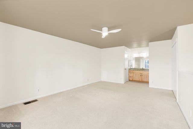 a view of a room with a kitchen