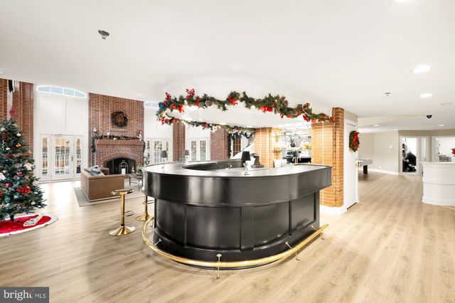 a living room with fireplace furniture and a large window