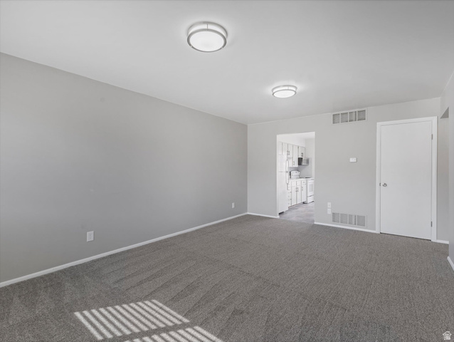 1478 North 75 West, Unit AD Sunset, UT 84015 - Photo 9 of 26 Empty room featuring dark carpet
