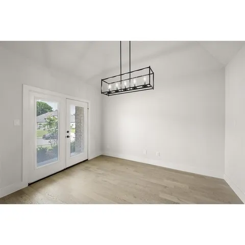 a view of a room with wooden floor