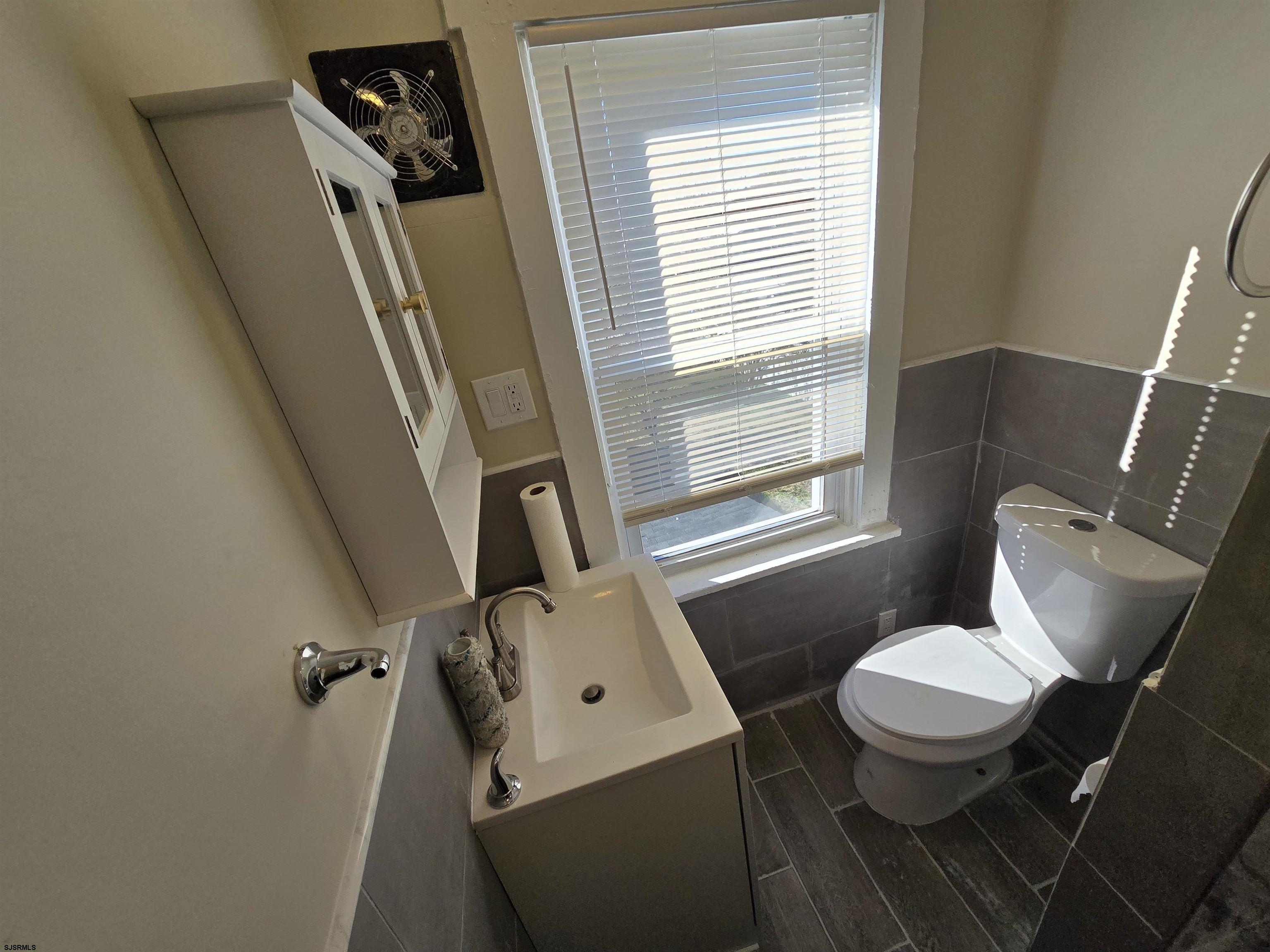 1528 Madison Avenue, Unit B Atlantic City, NJ 08401 - Photo 11 of 12 a white toilet sitting next to a window