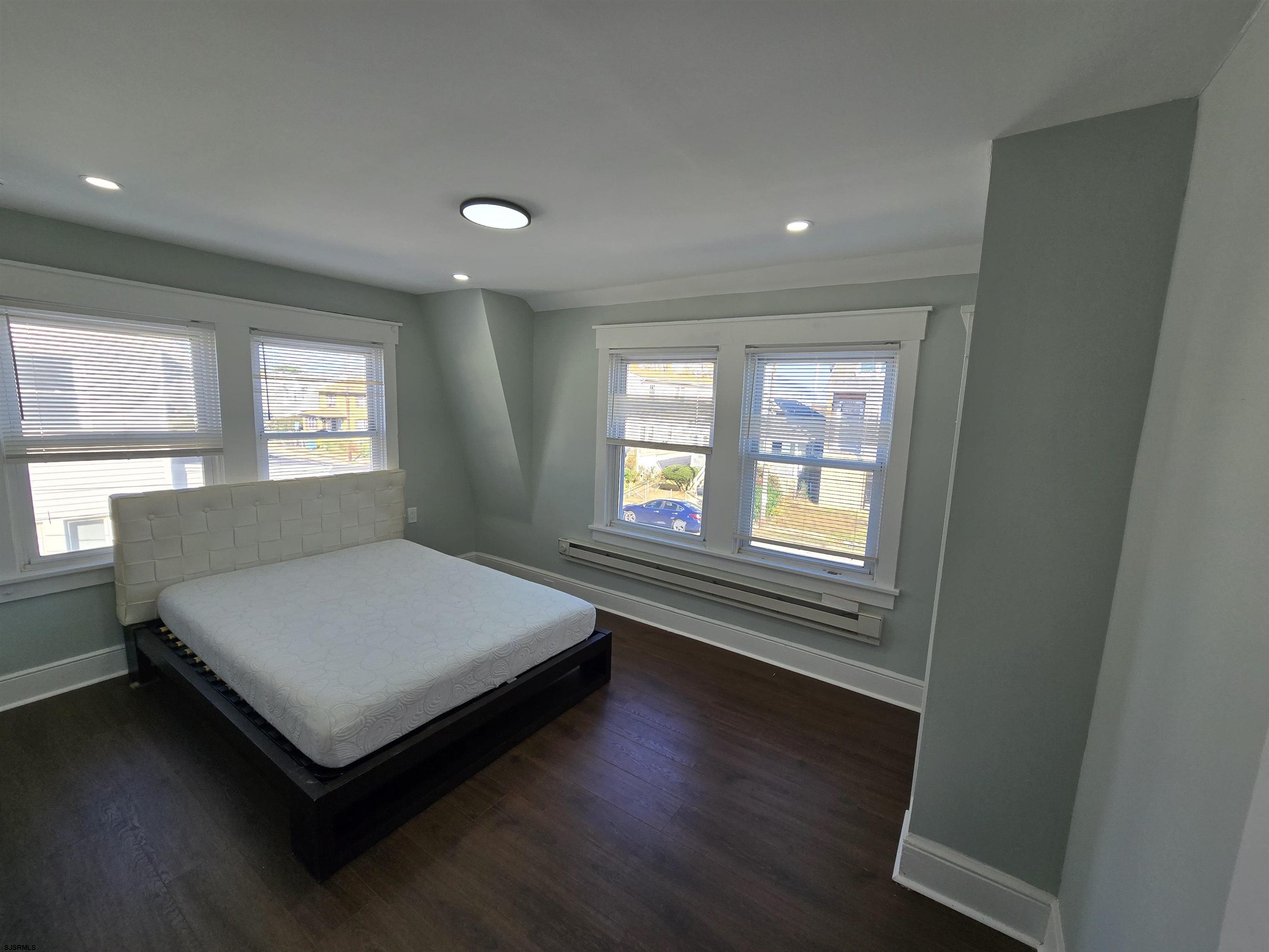 1528 Madison Avenue, Unit B Atlantic City, NJ 08401 - Photo 4 of 12 a bed sitting in a spacious bedroom next to a window