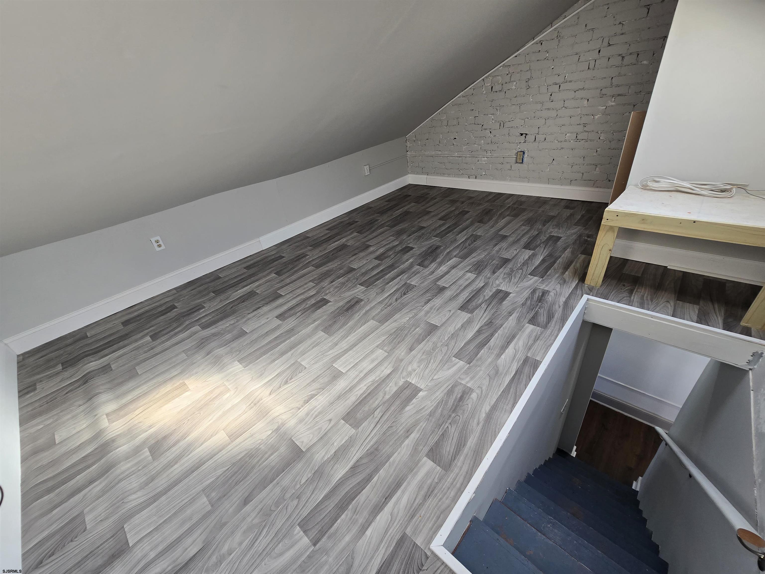 1528 Madison Avenue, Unit B Atlantic City, NJ 08401 - Photo 6 of 12 a view of wooden floor and staircase