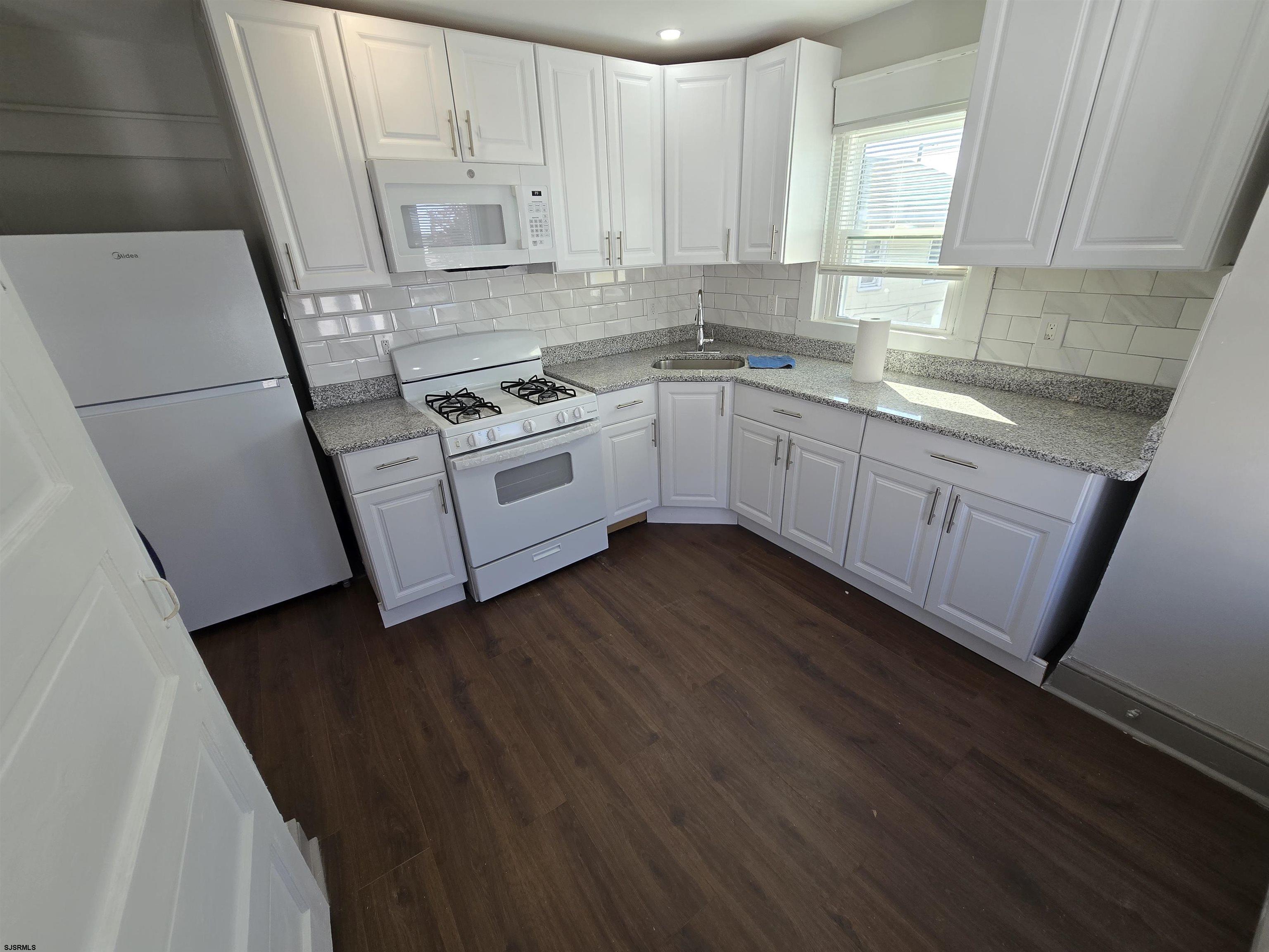 1528 Madison Avenue, Unit B Atlantic City, NJ 08401 - Photo 9 of 12 a kitchen with cabinets a sink and appliances
